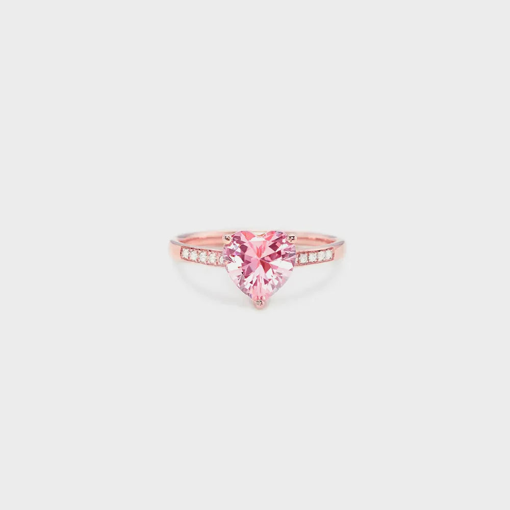 Rose gold ring with a pink heart-cut pavé stone and diamond accents.