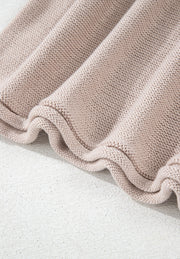 Beige knit sweater with ruffled hem detail