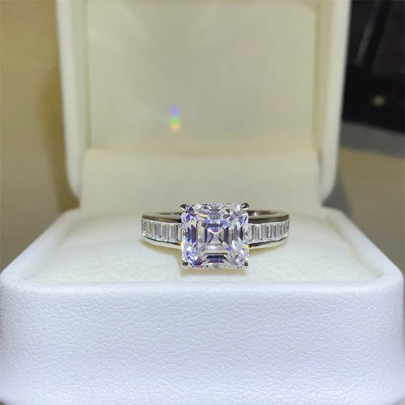 Silver ring with a large emerald cut center stone and baguette accents.