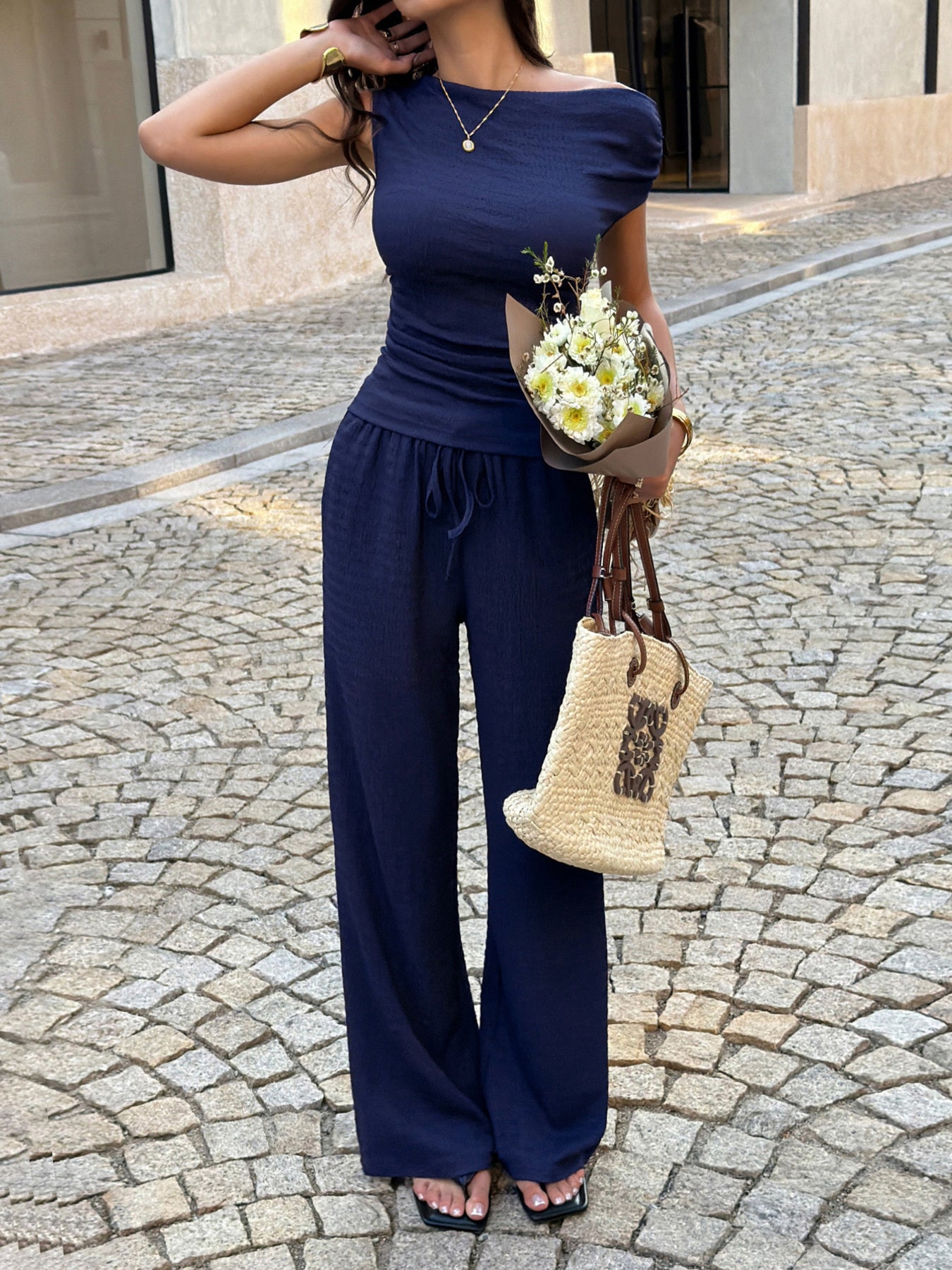 Navy ruched asymmetrical top and wide-leg pants set with drawstring waist.