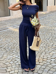 Navy ruched asymmetrical top and wide-leg pants set with drawstring waist.