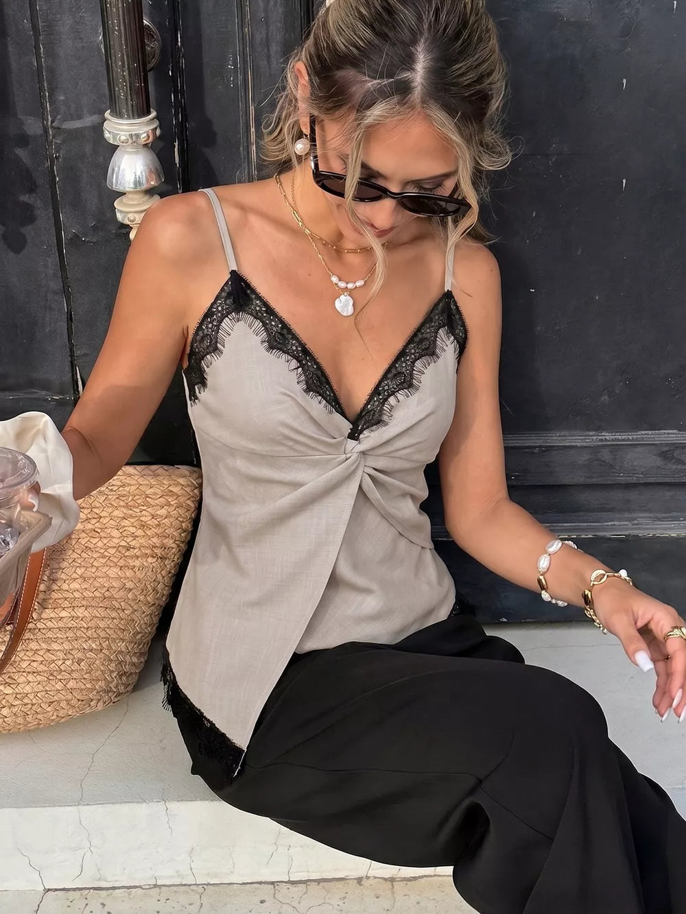 Luxe cami top in beige with black lace trim and twisted front detail.
