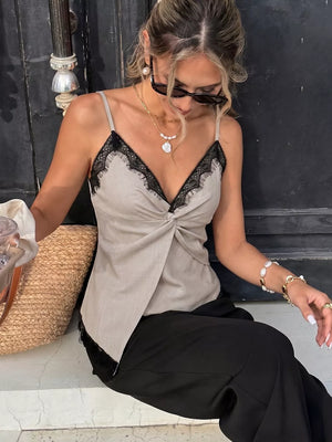 Luxe cami top in beige with black lace trim and twisted front detail.