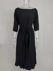 Black off-the-shoulder belted midi dress with 3/4 sleeves and a tie waist.
