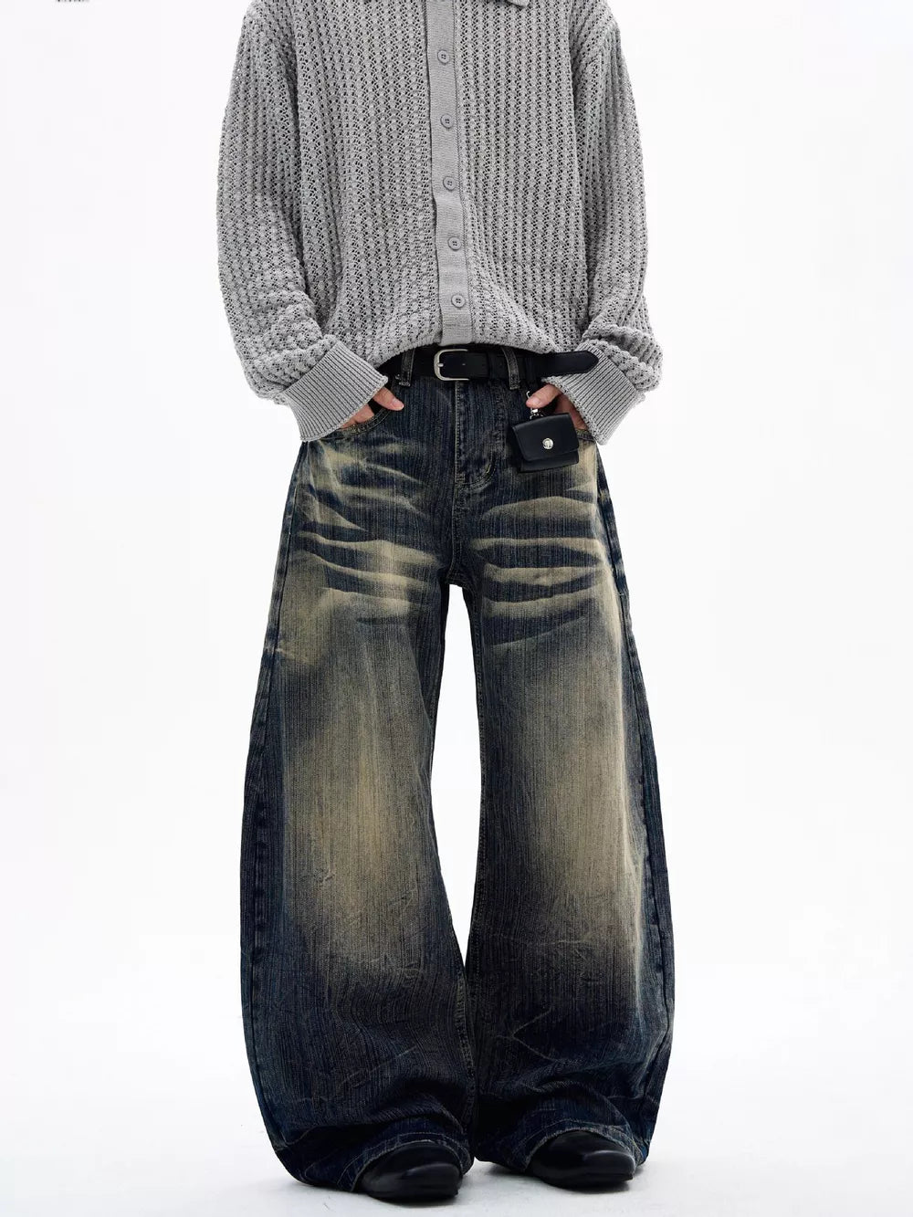 Men's vintage wash wide leg jeans with distressed detailing and a relaxed fit.