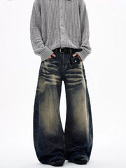 Men's vintage wash wide leg jeans with distressed detailing and a relaxed fit.