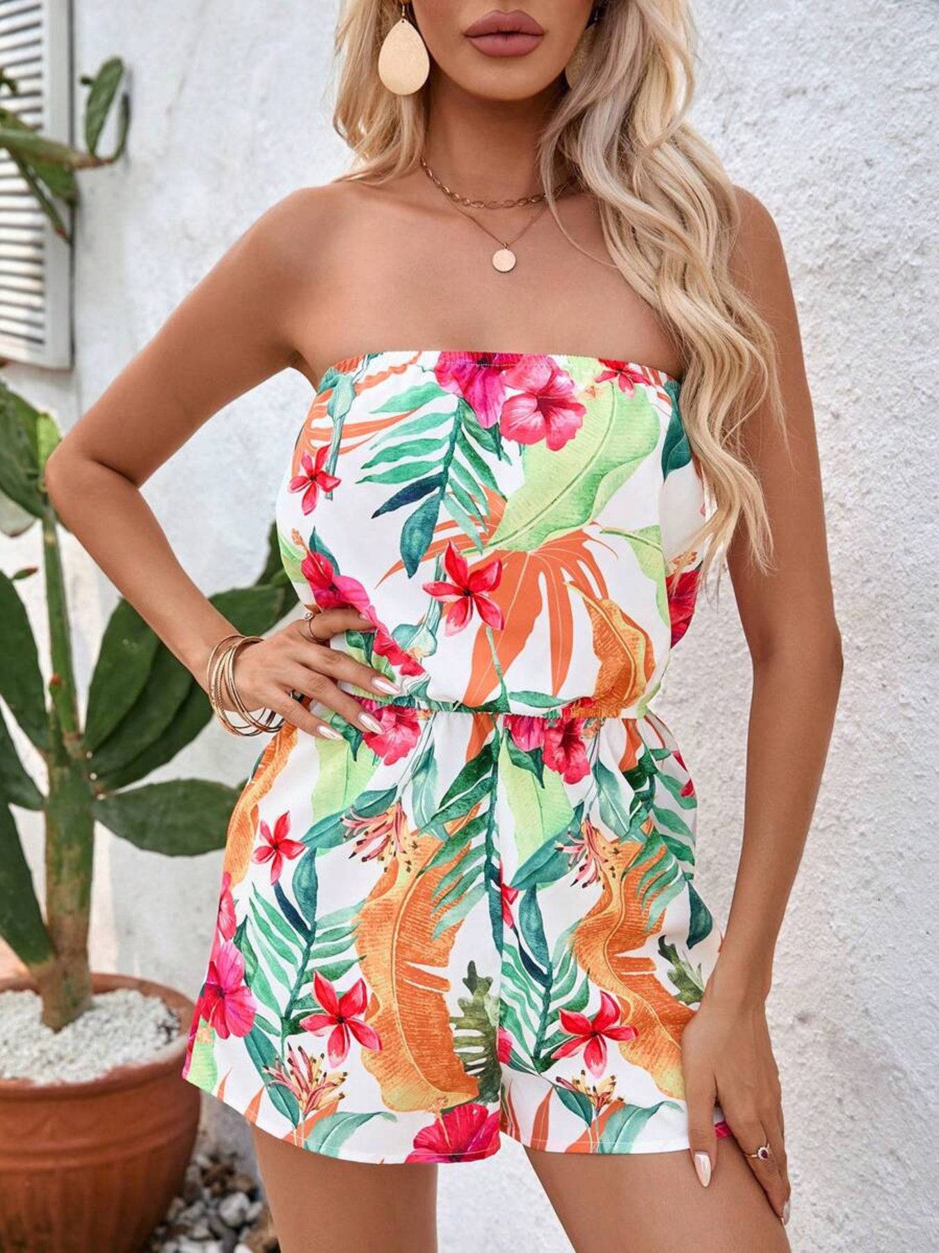 Strapless romper with colorful tropical floral print and elasticized waist.