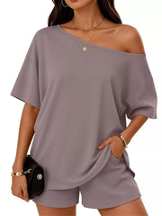 Light gray asymmetrical one-shoulder top with pockets and matching shorts set.