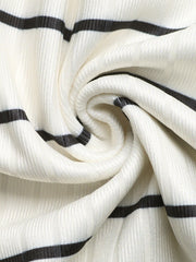 Sleeveless ribbed knit midi dress in cream with black stripes, form-fitting silhouette.