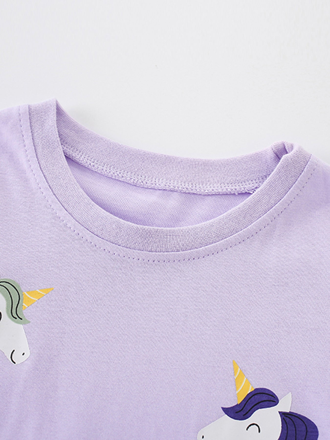 Lavender cotton toddler t-shirt with whimsical unicorn graphic and crew neck.