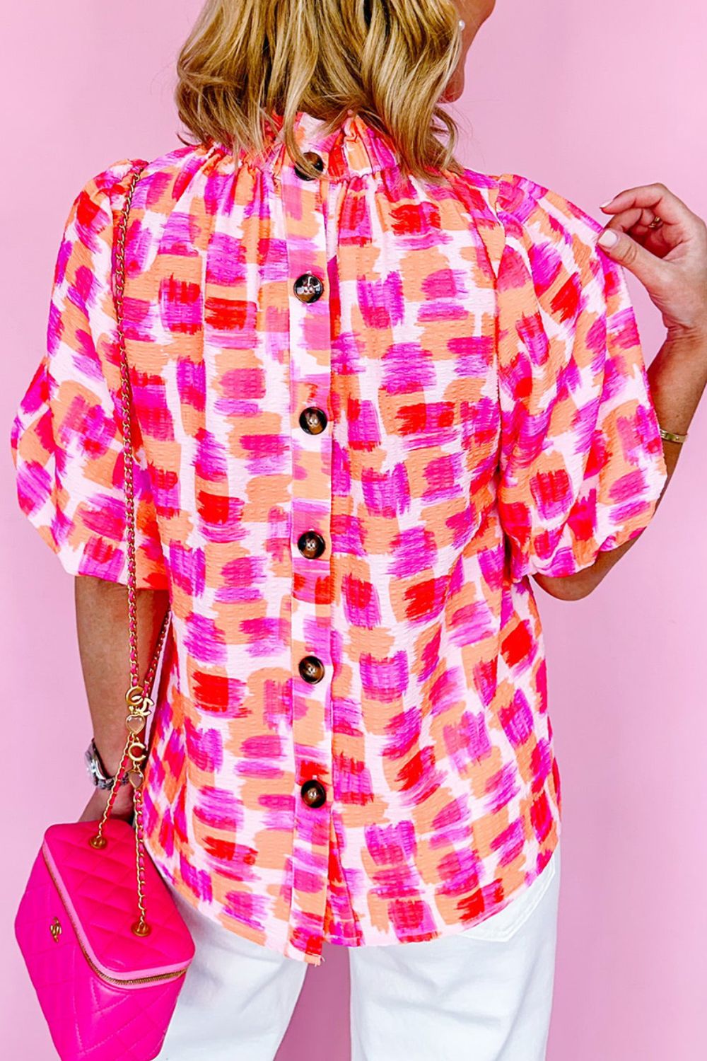 Brushstroke print blouse with ruffled neckline and button back detail.