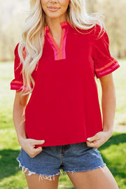 Red maternity blouse with ruffled sleeves and striped neckline and cuffs