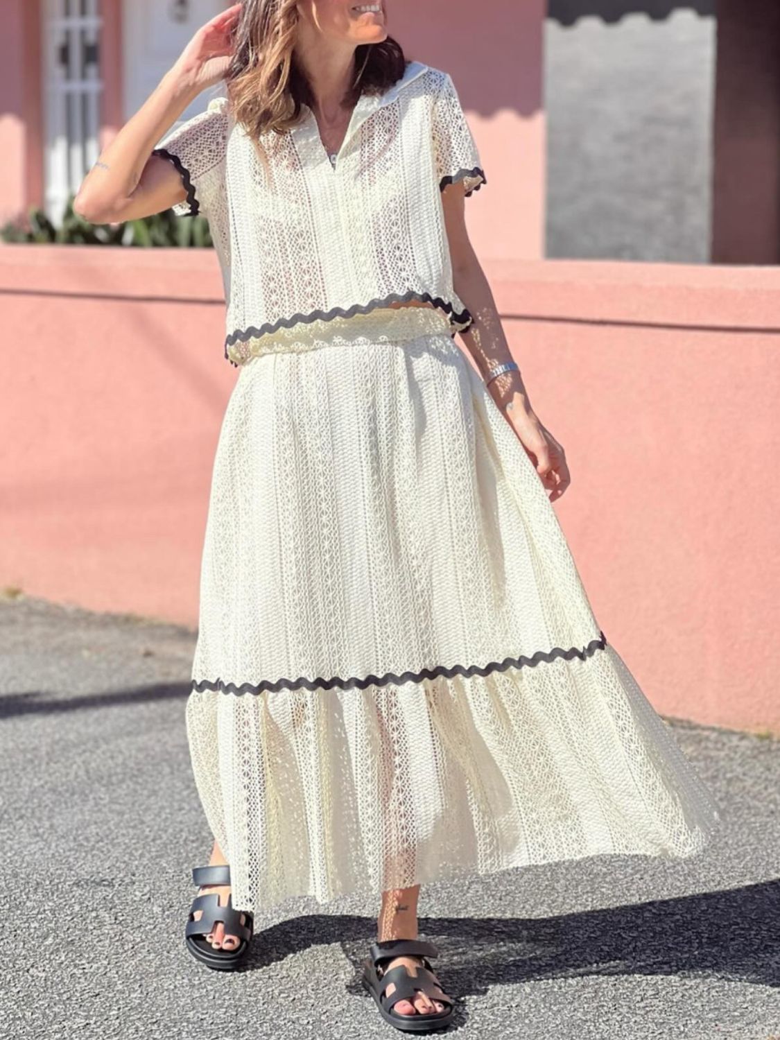 Cream crochet co-ord set with scalloped trim, short sleeves, and midi skirt.
