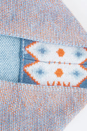 Blue knit cardigan with geometric trim detail and flecked texture.