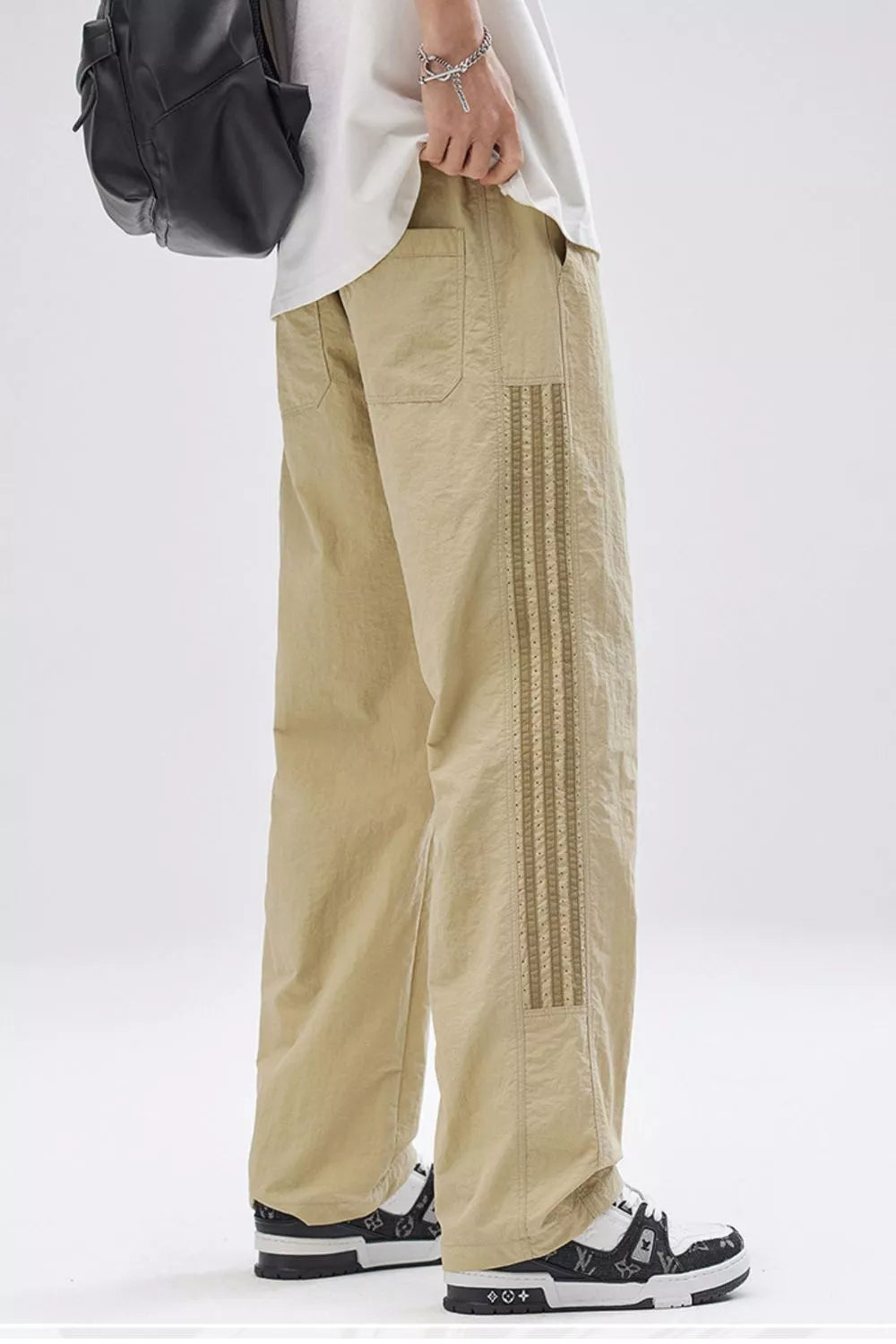 Men's khaki wide-leg cargo pants with decorative side stripe detail and front pockets.
