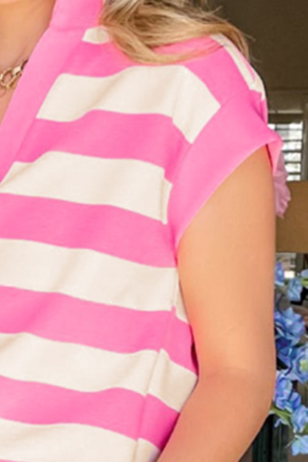 Pink and white striped V-neck tee with short sleeves.