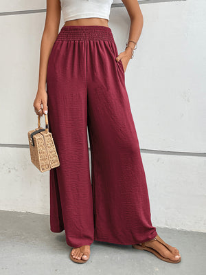 Burgundy textured palazzo lounge trousers with smocked waist and wide legs.