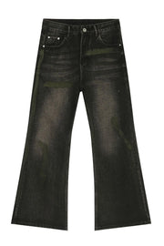 Dark wash bootcut jeans with green paint-like accents and a faded effect.