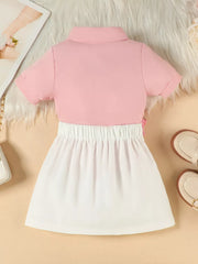 Toddler pink polo shirt and white skirt set with floral appliqué detail