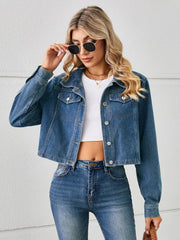 Cropped denim trucker jacket in Dusty Blue with button closure and chest pockets.