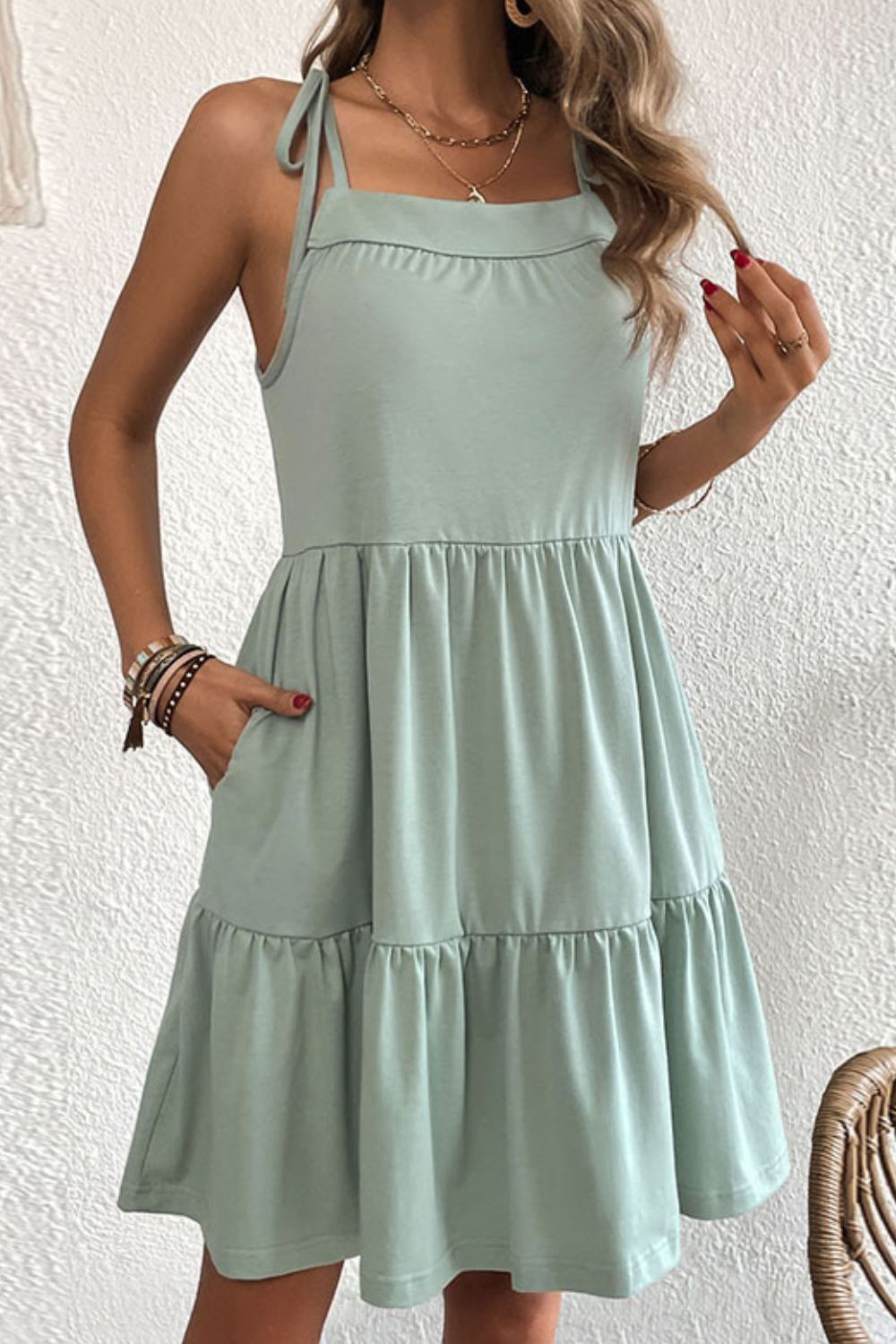 Light green tie-strap mini dress with ruffle hem and pockets