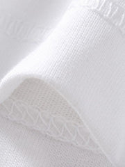 White cotton polo shirt detail showing fabric texture and stitching.