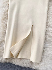 Chic off-white knit midi skirt with a side split detail.