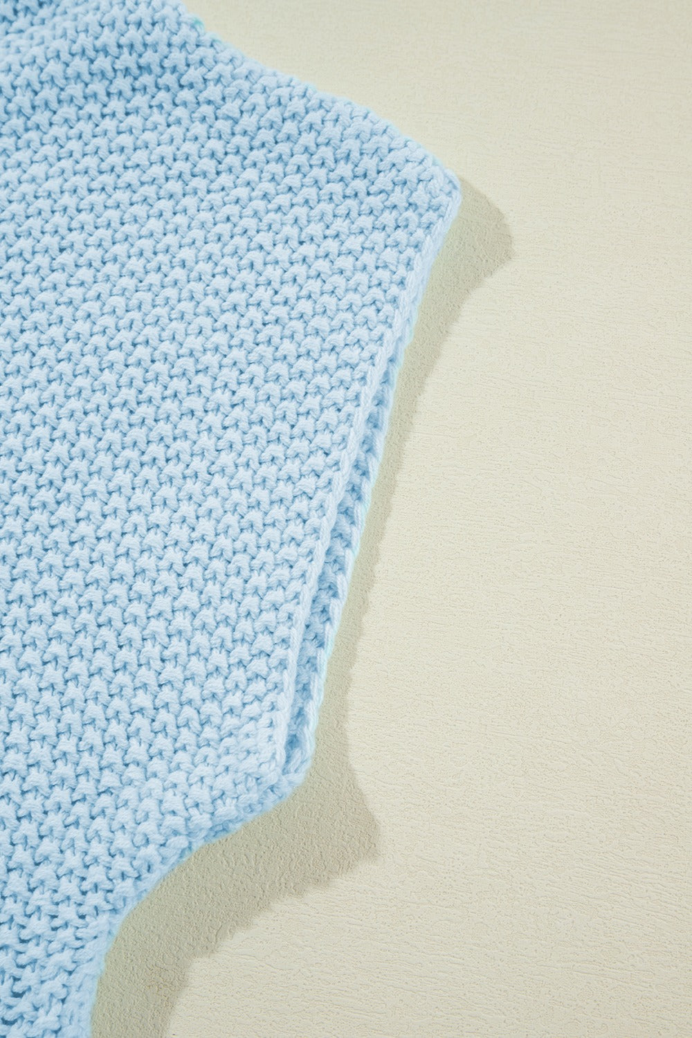 Light blue knit turtleneck shell sweater with textured stitch detail