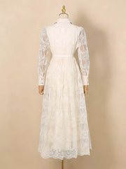 White lace midi dress with button placket, collared neckline, and sheer sleeves.