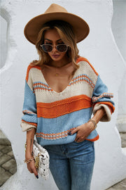 Deep plunge stripe knit pullover sweater in blue, orange, and cream acrylic with a V-neck.