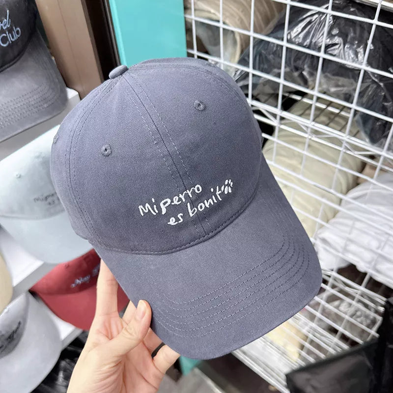 Dark Gray baseball cap with "Mi perro es bonit" embroidery and paw print detail.