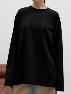 Black oversized crewneck sweatshirt with voluminous sleeves and a relaxed fit.