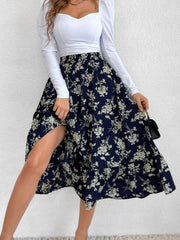Navy floral print midi skirt with tiered ruffles and a side slit.