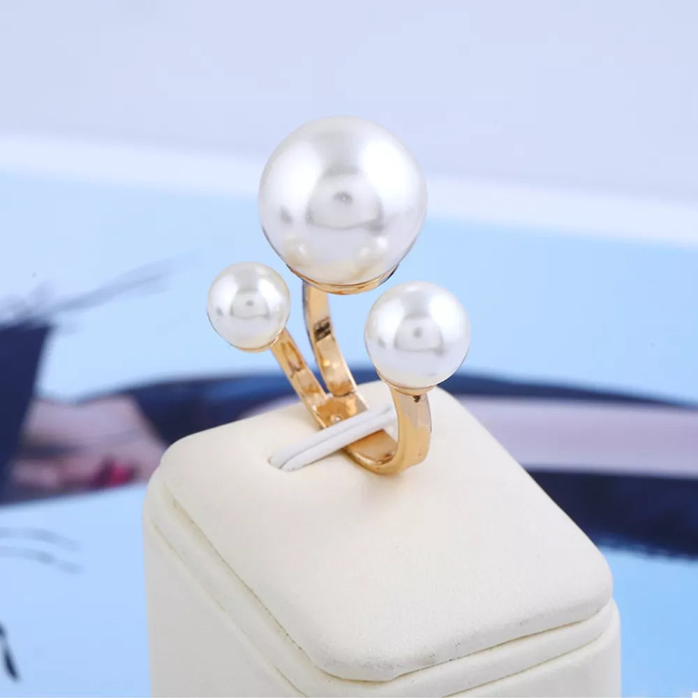 Elegant gold-plated open ring with three pearls, a chic accessory for women.