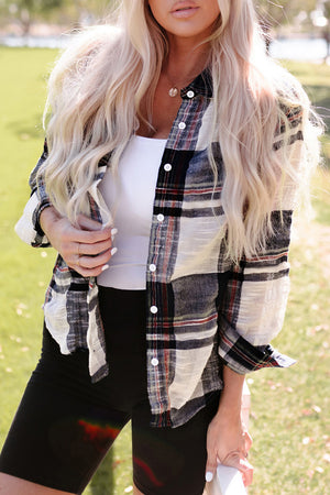 Linen plaid button-down overshirt with white buttons, styled open over a white tank top.