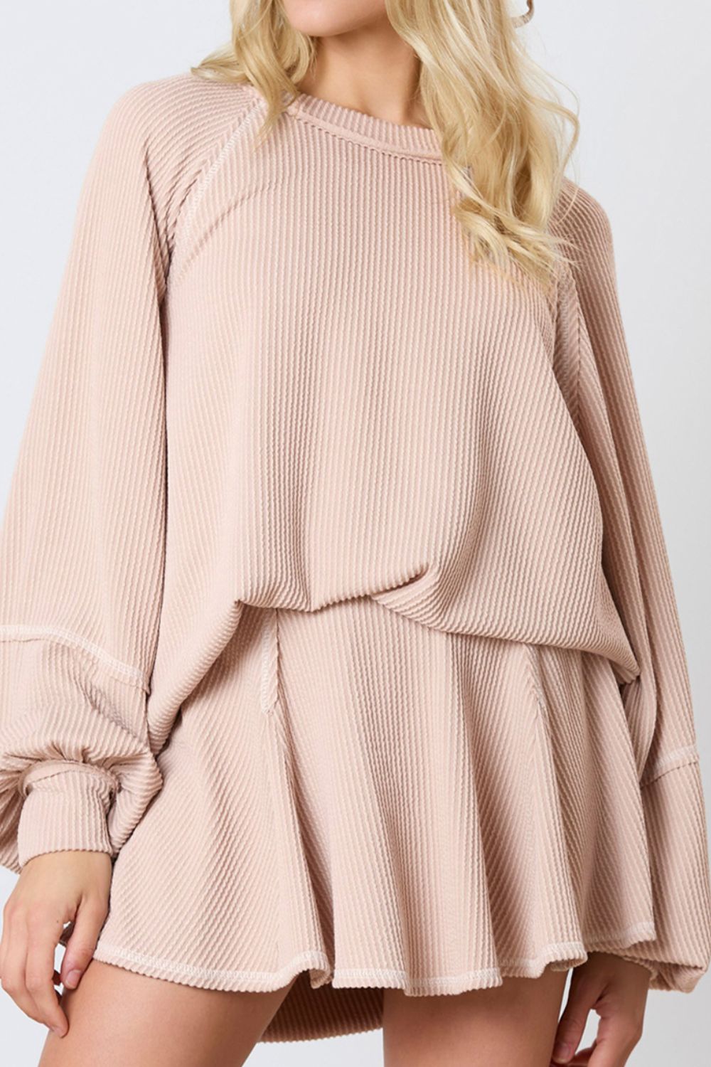 Apricot ribbed loungewear set with raglan sleeves and flared shorts.