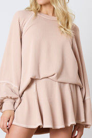 Apricot ribbed loungewear set with raglan sleeves and flared shorts.