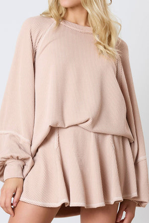 Apricot ribbed loungewear set with raglan sleeves and flared shorts.