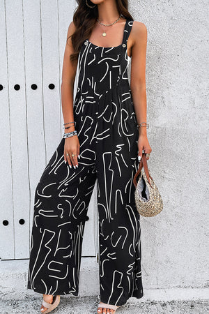 Black abstract scribble wide leg jumpsuit with button straps and side slits.