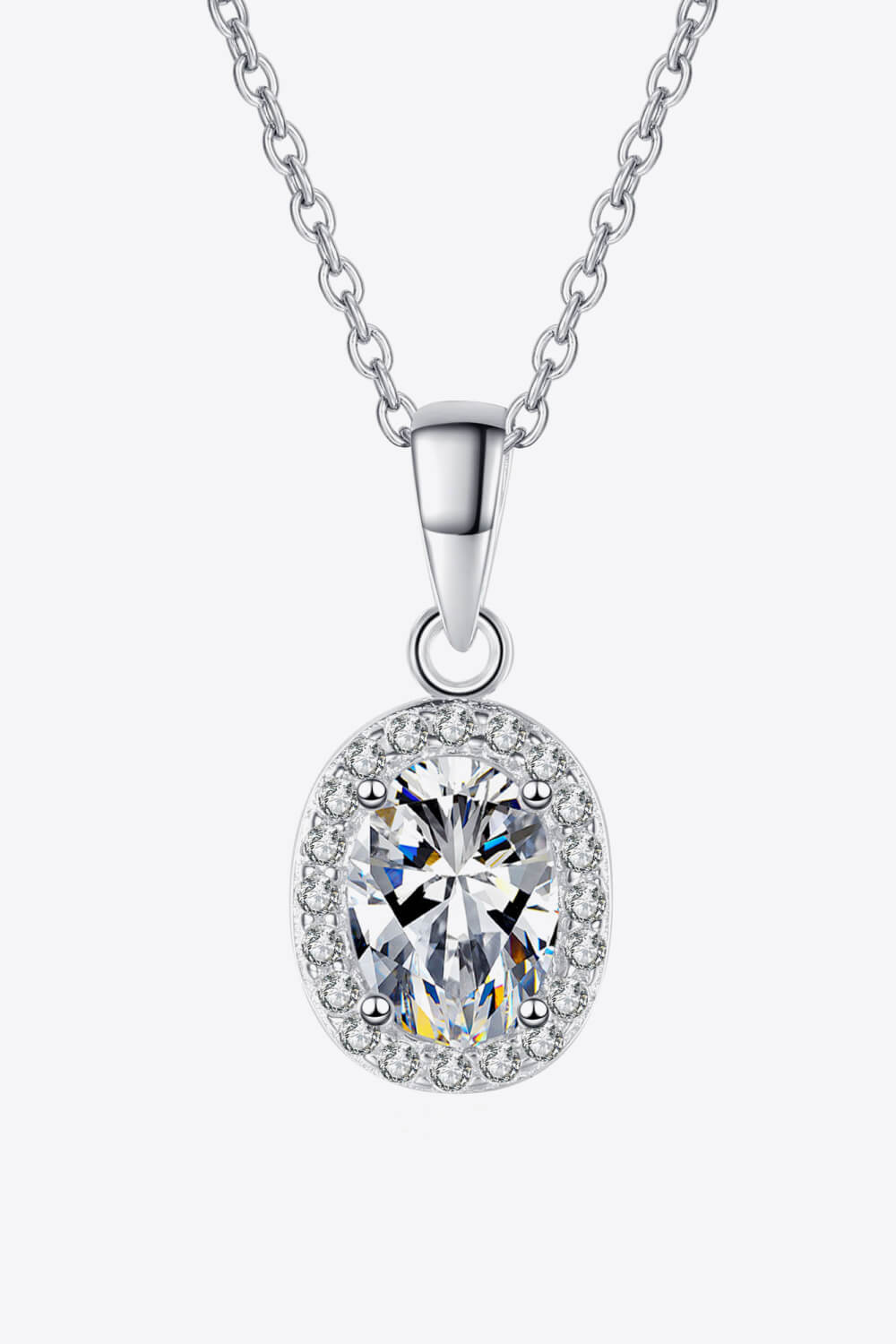 Silver halo moissanite pendant necklace with oval-cut center stone on sterling silver chain.