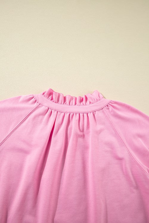 Pink cotton co-ord set with ruffled neckline and gathered detail