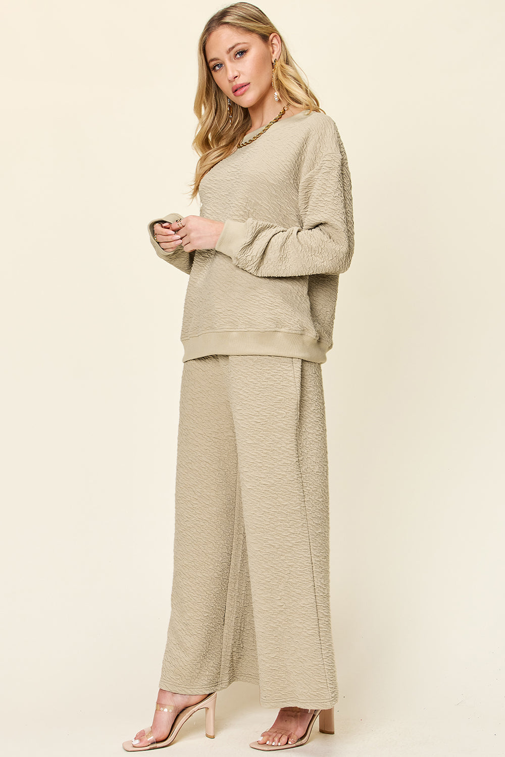 Textured loungewear set in tan with crewneck sweatshirt and wide leg pants.