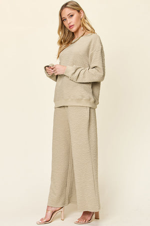 Textured loungewear set in tan with crewneck sweatshirt and wide leg pants.