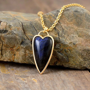 Gold chain necklace with a heart-shaped labradorite pendant, boho style.