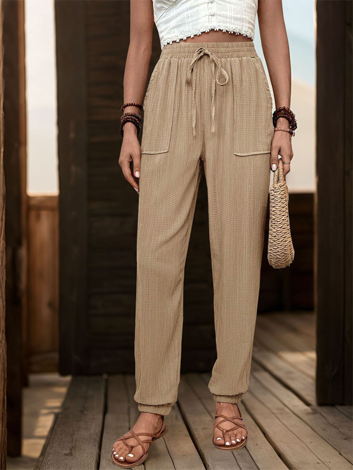 Tan textured drawstring waist relaxed trousers with cuffed ankles and patch pockets.