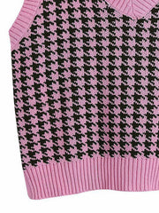 Houndstooth knit v-neck tank top in pink and black with ribbed hem.
