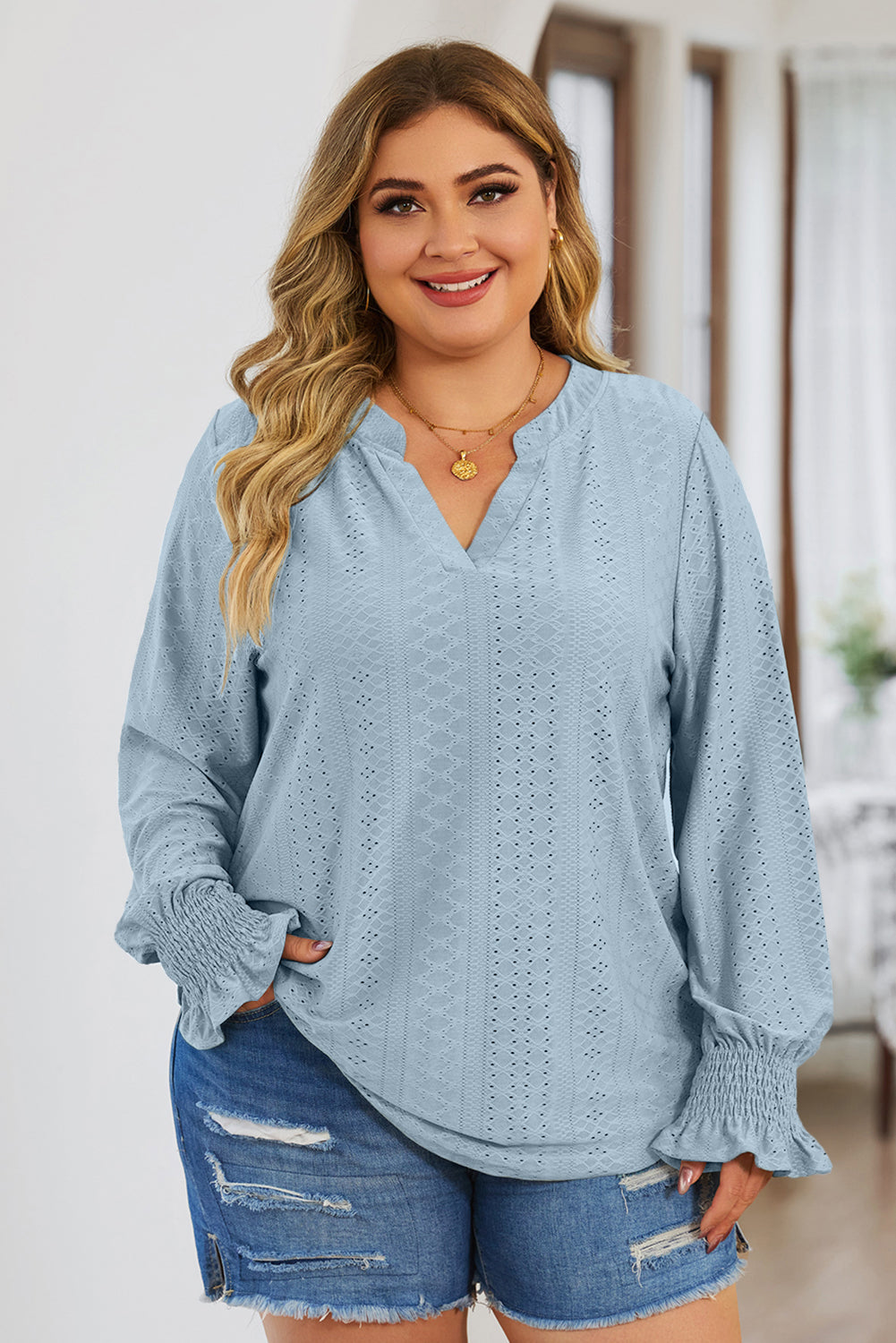 Light blue textured blouse with slit neck and shirred cuffs