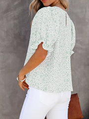 Maternity blouse in green floral print polyester with ruffle sleeves and smocked bodice.