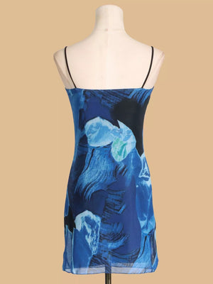 Blue abstract print spaghetti strap mini dress with sheer hem.