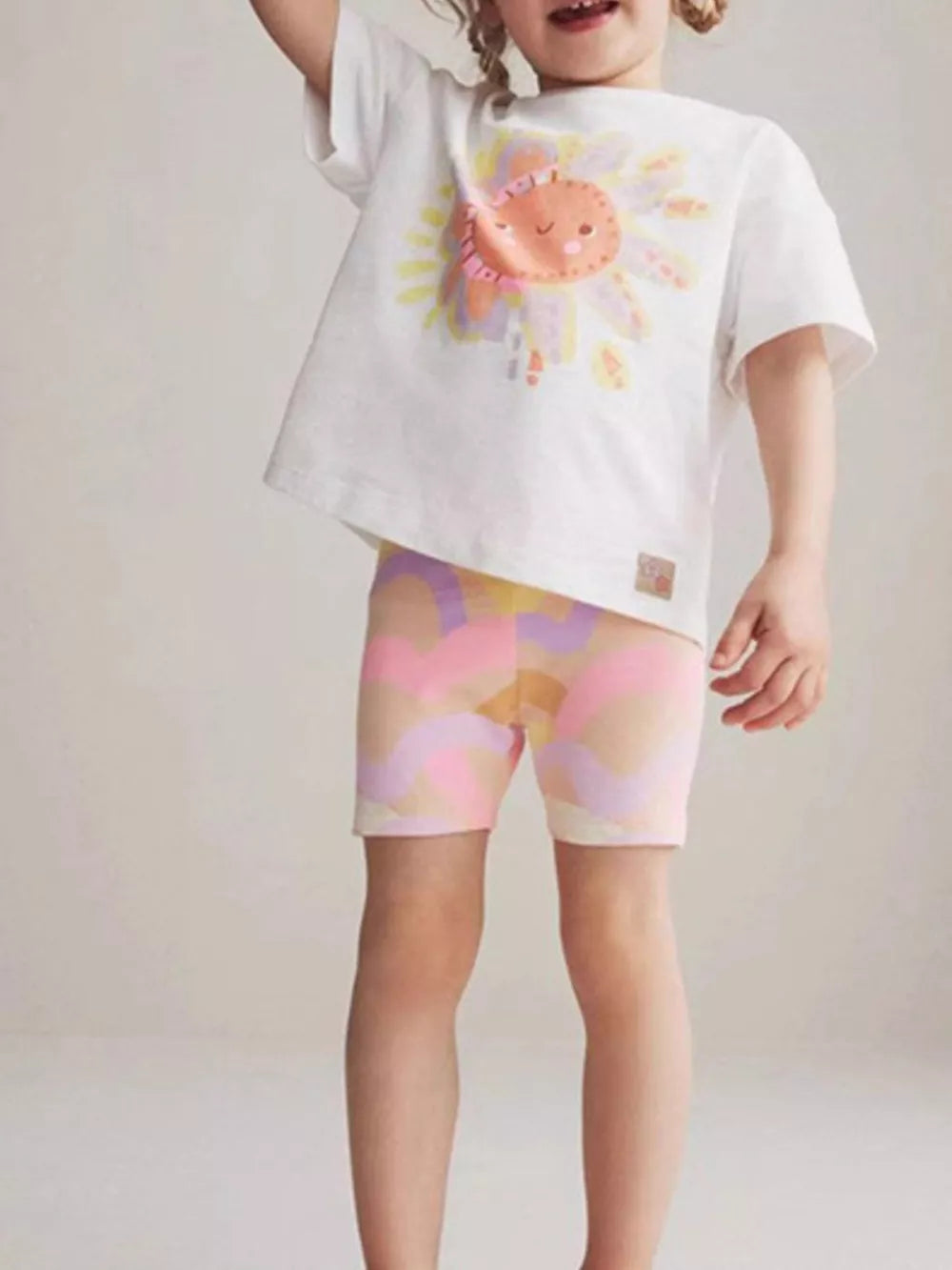 Playful cartoon sun cotton t-shirt for babies and children.
